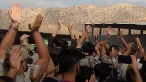 Protesters clapping in the air