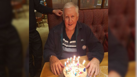 Brian Thomas sat with a birthday cake in front of him