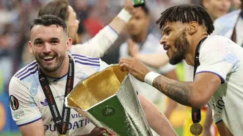 John McGinn and Tyrone Mings with the Europa League trophy