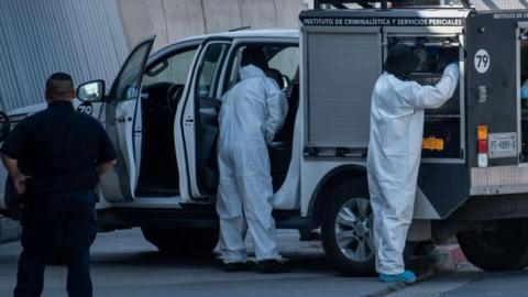 Forensic experts from the prosecutor's office of the state of Nuevo León work in the area where human remains were left in the municipality of San Nicolas in the state of Nuevo Leon, Mexico, 26 September 2023.