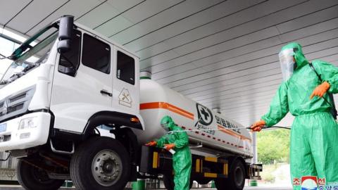 A photo released by the official North Korean Central News Agency (KCNA) on 19 May 2022 shows staff disinfecting the premises of a medical oxygen factory to curb the current coronavirus disease health crisis in Pyongyang, North Korea