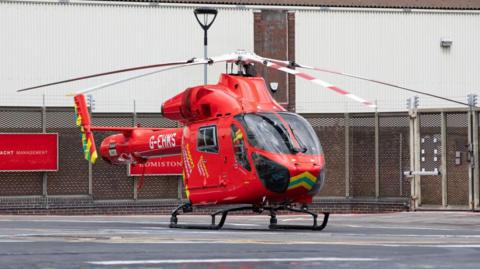 Red air ambulance helicopter on the ground