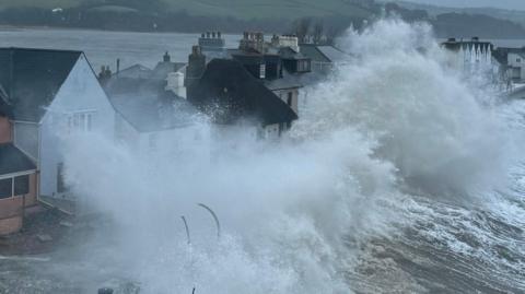 A view of waves breaking over the sea defences in Torcross, Devon, during the winter storms in January and February, 2026