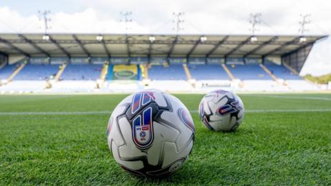 A football on the field at the Kassam Stadium in Oxford.