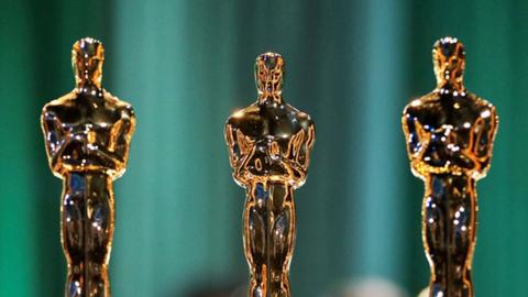 Three Oscar statuettes in a row