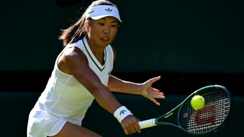 Mimi Xu strikes the ball with her racquet