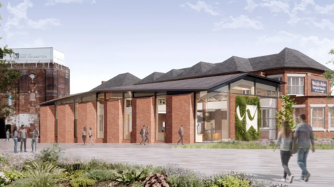 An artist's impression of what one building could look like. It is one level with red brick walls and large, glass windows in between and a grey slanting roof. It is joined to a taller building on the right in a similar design. People are walking on a grey path by the building and another taller, brick building can be seen in the distance.