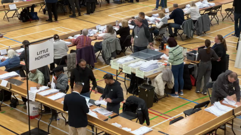 Vote counters in a sports hall