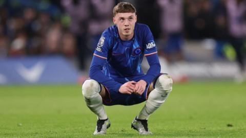 Cole Palmer crouches down during Chelsea's win over Southampton