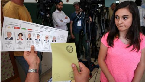 A young woman is seen with a ballot paper at a polling station during snap twin Turkish presidential and parliamentary elections in Ankara, on June 24, 2018.
