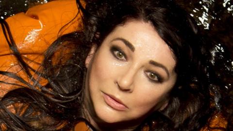 Kate Bush, wearing a life vest in water, in a promotional image for her 2014 album Before the Dawn