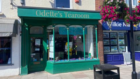 Odette's Tearoom exterior - a green building with a large glass front.