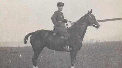 A black and white photograph of an officer on a war horse