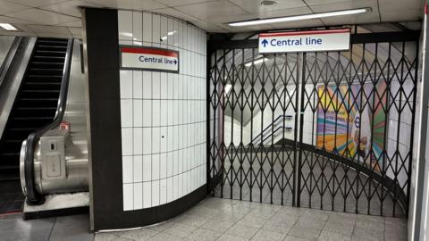 Shuttered gates in Tube station with signs pointing to Central line