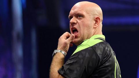 Michael van Gerwen in green and black darts outfit