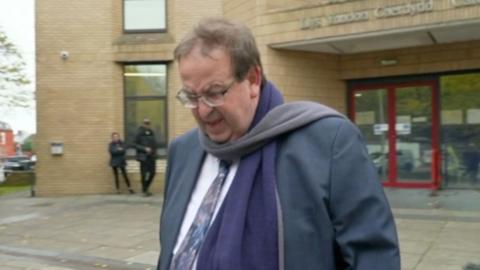 Priest leaving court