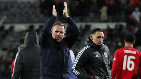 Wales boss Craig Bellamy applauds the crowd