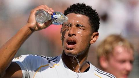 Jude Bellingham pours water over his face while playing for Real Madrid at the Club World Cup