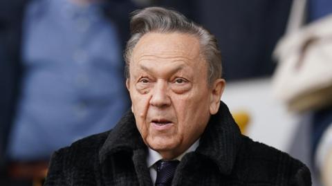 David Sullivan, wearing a dark coat and tie, shown down to his shoulders.