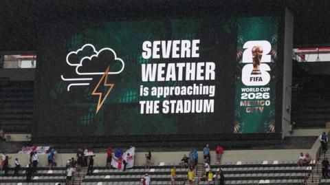 A sign displays 'Severe weather is approaching the stadium' at Mexico City's Azteca Stadium