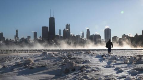 Man walks along frozen Chicago lakeside