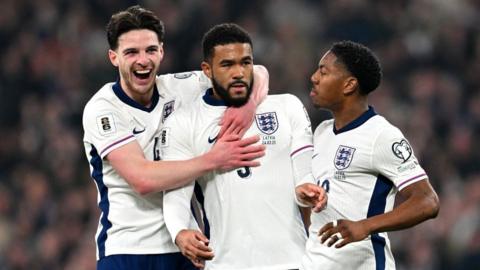 Declan Rice, Reece James and Myles Lewis-Skelly celebrate the England defender's goal against Latvia