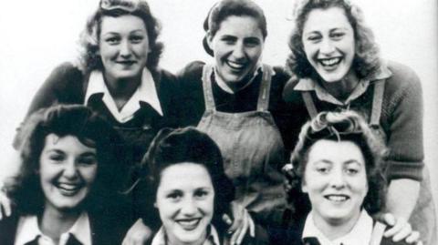 A black and white photograph featuring six women working at the home front dated from the Second World War.