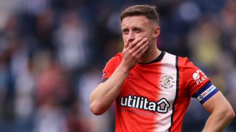 Jordan Clark of Luton Town looks dejected