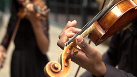 Closeup of a black violinist's hand playing