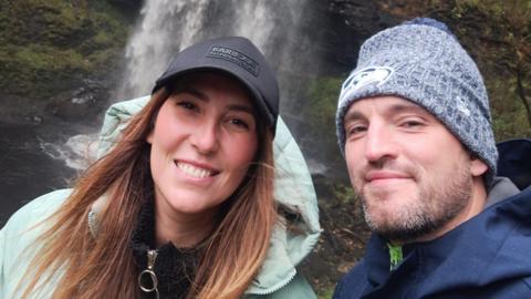 Leah Matthews and her partner pictured shortly before her fall, smiling at the camera