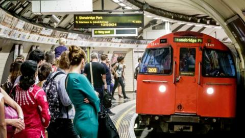 Bakerloo Line train and commuters