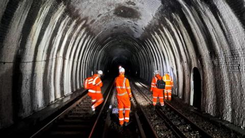 The Blackheath tunnel inspected by four men in orange jackets