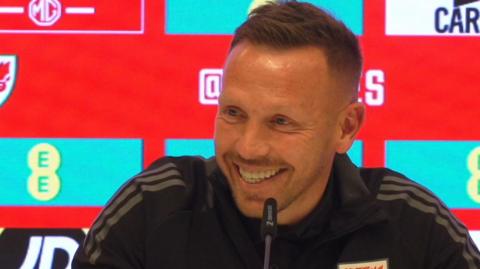 Craig Bellamy smiles as he speaks to the media