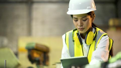 Woman using a tablet in a factory