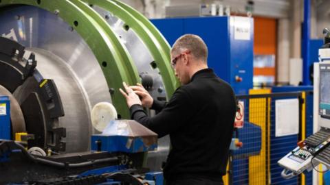 An employee works on a Magnetic Resonance Imaging (MRI) scanner on the manufacturing production line at the Siemens Healthineers factory near Oxford, UK, on Wednesday, Jan. 29, 2025. 