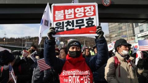 Pro-Yoon Suk Yeol supporters gather near the official residence of impeached South Korean President Yoon Suk Yeol on January 03, 2025 in Seoul, South Korea. 