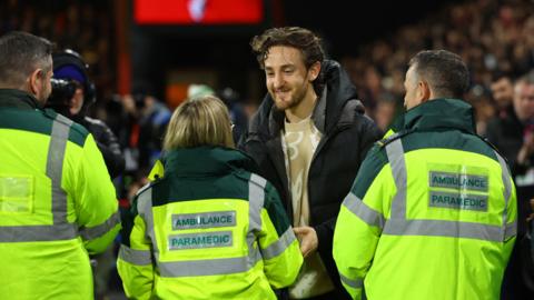 Tom Lockyer shaking hands with medics before Luton's game at Bournemouth