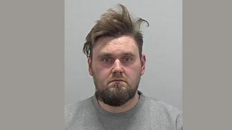 picture of Albert jarosz wearing a grey jumper in police mugshot