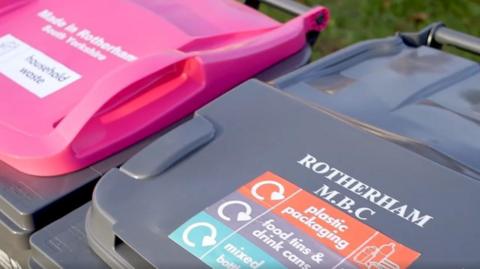 A close-up of two bins with Rotherham MBC printed on the lid