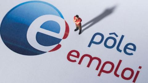 A figurine next to the logo of 'Pole Emploi', the French governmental agency for unemployed people, on August 27, 2018 in Paris