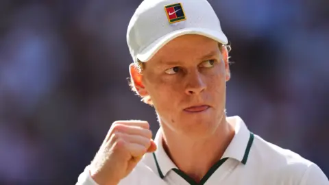 Jannik Sinner celebrates with a clenched fist
