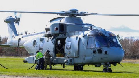 A large Royal Navy helicopter is refuelled