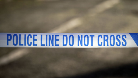 A close-up photo of a blue and white police tape
