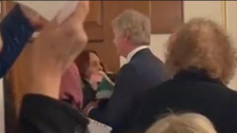 Councillor approaching a woman in meeting