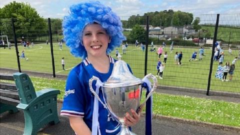 Loughgall youth team player Sophie holding the championship trophy.