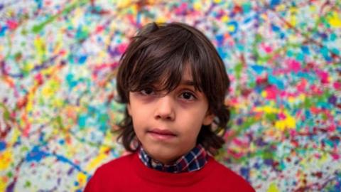 Mikail Akar, seven, says painting can be exhausting