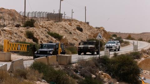 Vehicles drive along Israel's border with Egypt, near where three Israeli soldiers were killed by an Egyptian policeman (3 June 2023)