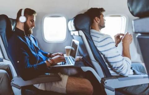 Two men seated on an aeroplane