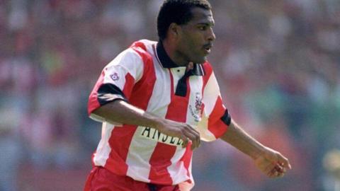 Tony Kelly wearing a red and white striped top