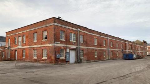 The former rum store building, a long, naval-looking two-storey brick building